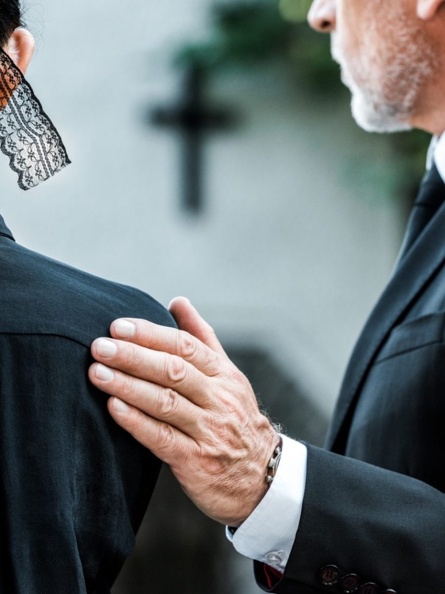 cropped-view-of-man-touching-woman-on-funeral-e1636904690263.jpg